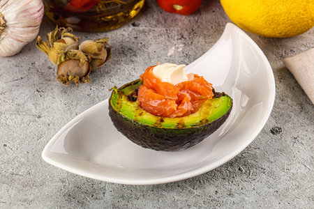 Whole grilled avocado with salmon and sauceの写真素材