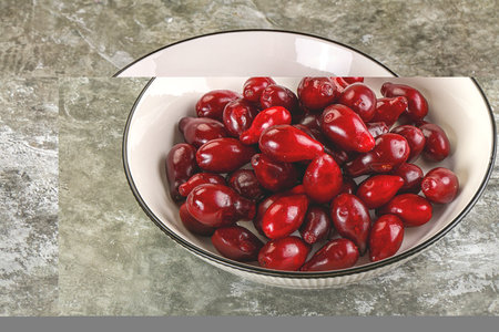 Ripe sweet juicy cornel in the bowl