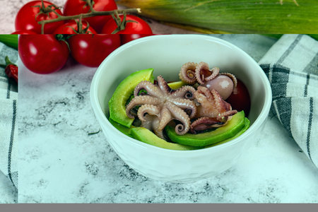 Salad with baby octopus, tomato and avocadoの写真素材
