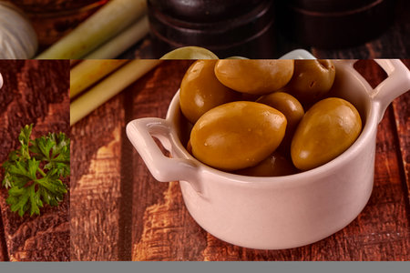 Greek green olives heap marinated in the bowlの写真素材