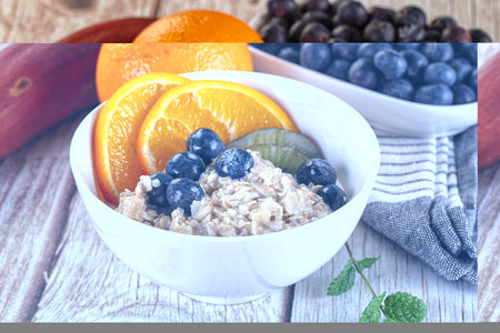 Oats porridge with blueberry, kiwi and orange fruits
