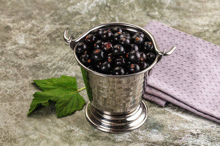 Ripe black currant in the bowl served leafの写真素材