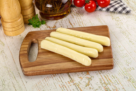 White mozzarella sticks over board snack