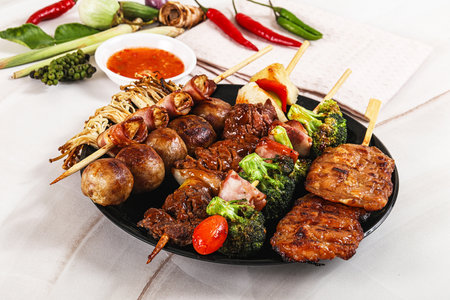 Asian grilled skewer assortment satay with beef, porl, chicken and vegetablesの写真素材