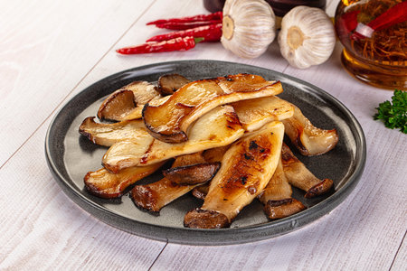 Vegan cuisine - Roasted eringi mushrooms in the plateの写真素材