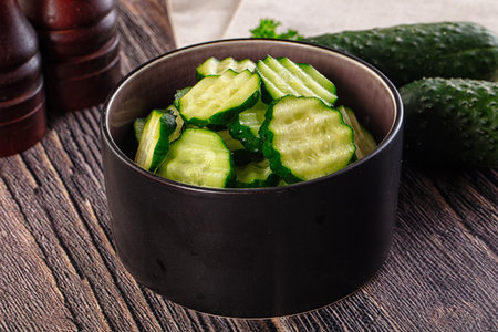 Fresh green ripe cucumber slices in the bowlの写真素材