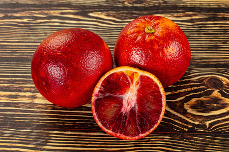 Red sweet juicy orange fruit with half sliceの写真素材