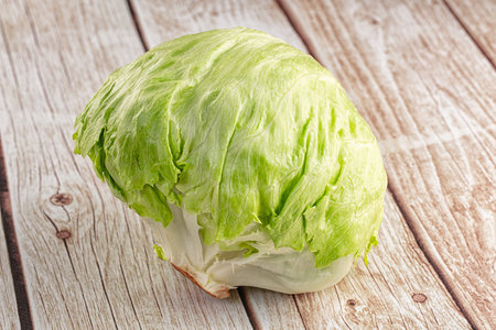 Raw fresh greeniceberg salad over backgroundの写真素材