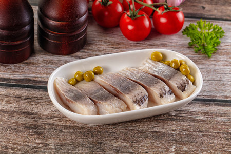 Slided marinated salted herring fillet with green peasの写真素材