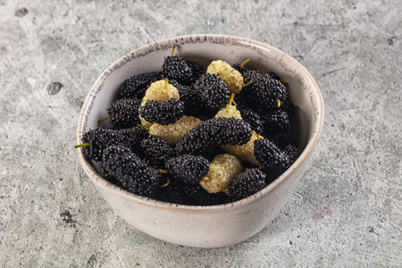 Ripe sweet juicy black and white mullberry in th the bowl