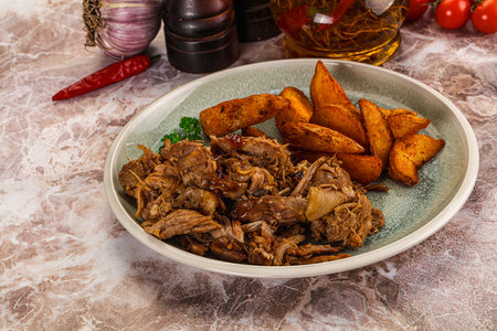 Baked shredded pork with potatoes and spices