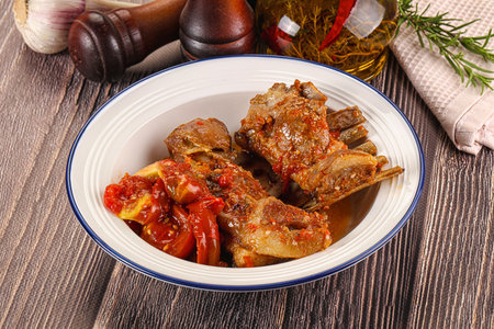 Baked lamb ribs with vegetables and spicesの写真素材