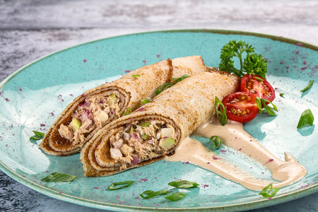 Stuffed pancake with tuna, egg and sauceの写真素材