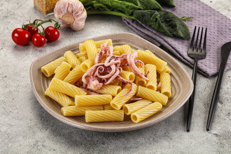 Italian cuisine - pasta tortiglioni with squid tentaclesの写真素材