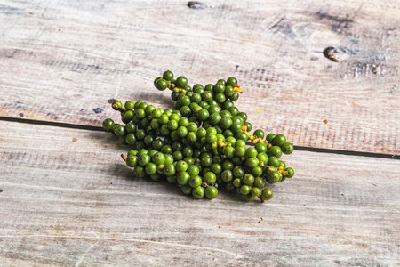 Green pepper corn on the branch heapの写真素材