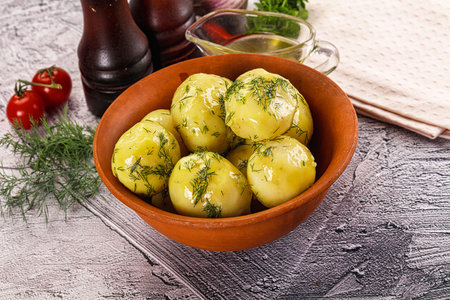Young boiled potato with dill and oilの写真素材