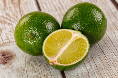 Ripe ggeen juicy lime heap with half slice
