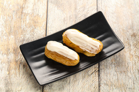 Delicious tasty eclair with ising and creamの写真素材
