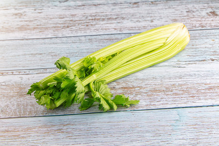 Raw green selery stem with leaves for cookingの写真素材