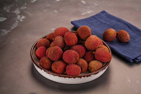 Sweet juicy tropical fruit lychee heap in the bowl