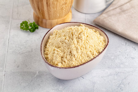 Yellow corn flour for bakery in the bowlの写真素材