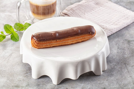 Gourmet chocolate eclair with brown icing