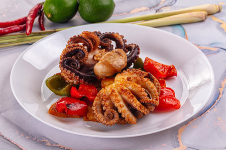 Gourmet grilled octopus with vegetables and sauceの写真素材