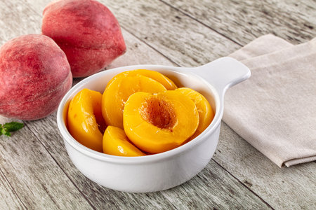 Sweet ripe yellow canned peaches piecesの写真素材