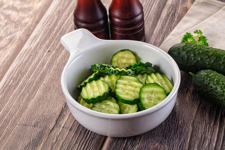 Fresh green ripe cucumber slices in the bowlの写真素材