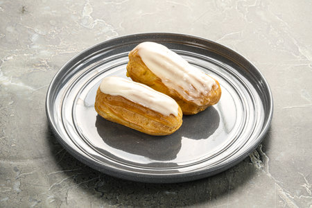Delicious tasty eclair with ising and cream