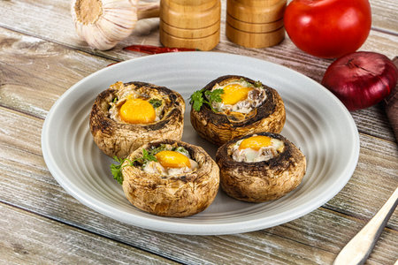 Baked champignon with quail egg and parsleyの写真素材