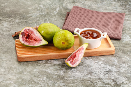 Tropical exotic green fig with cut over boardの写真素材