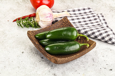 Mexican hot green Jalapeno pepper on the boardの写真素材