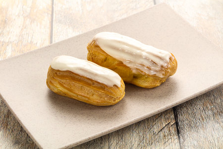 Delicious tasty eclair with ising and cream