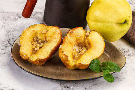 Baked quince with honey and cedar nutsの写真素材