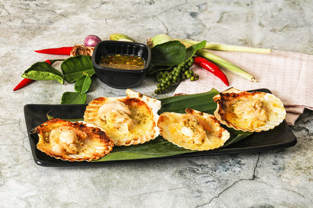 Griiled scallops in shell with cheese served sauce