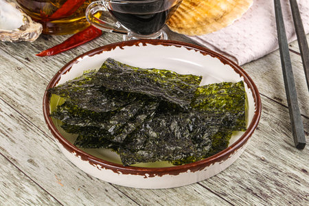 Vegan snack Green nori seaweed chips with soya sauceの写真素材