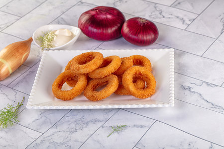 Golden fried breaded onion rings snackの写真素材