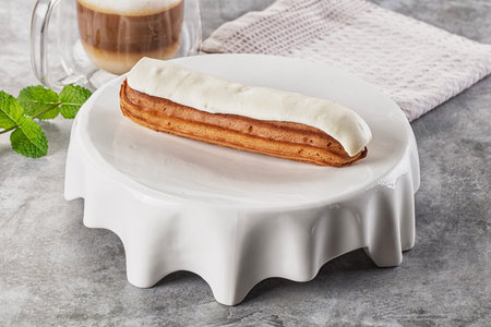 White delicous vanilla eclair with icing dessert
