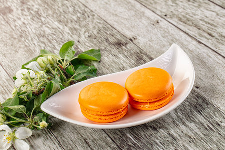 Sweet almond cookies orange macaroons served flowerの写真素材