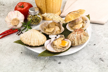 Raw fresh scallops in the shell for cooking