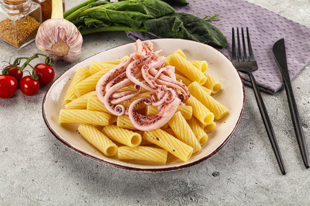 Italian cuisine - pasta tortiglioni with squid tentaclesの写真素材