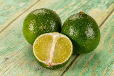 Ripe ggeen juicy lime heap with half slice