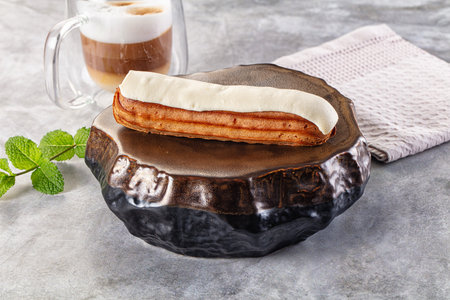 White delicous vanilla eclair with icing dessert
