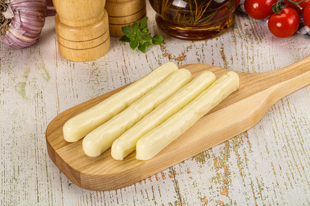 White mozzarella sticks over board snack