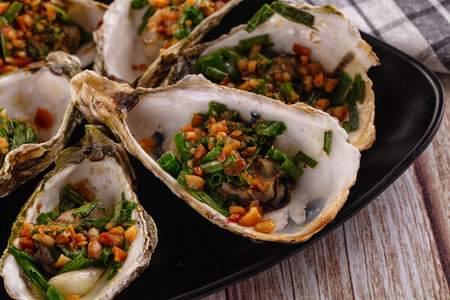 Gournet grilled oysters with green onion and peanutの写真素材