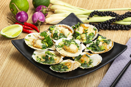 Grilled scallops with green onion and sauceの写真素材