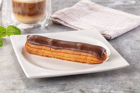 Gourmet chocolate eclair with brown icing