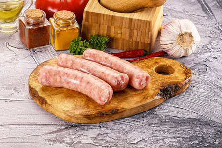 Raw meat sausages for grill over boardの写真素材