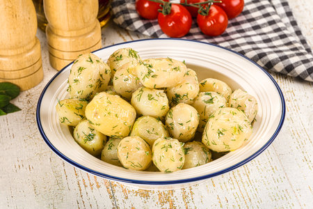 Young boiled mini potatoes with dill and butterの写真素材
